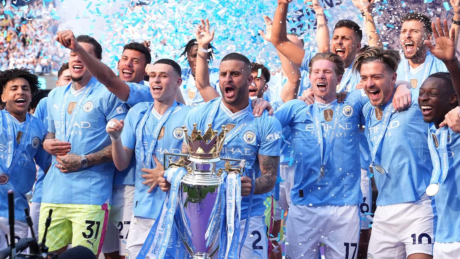 Manchester City's Kyle Walker lifts the Premier League trophy